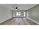 Living room with light walls, wood-look floors, and a ceiling fan at 4411 Mongite Rd, North Port, FL 34287