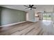 Open concept living room with wood-look floors and a green accent wall at 4411 Mongite Rd, North Port, FL 34287