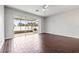 Bright living area with sliding doors to screened patio and dark tile flooring at 4842 Pond Ridge Dr, Riverview, FL 33578