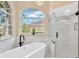 Luxurious bathroom with a freestanding tub, walk-in shower, and large window at 5212 Sunnydale Cir, Sarasota, FL 34233