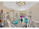 Bright dining room with a table set for dinner and hardwood floors at 5212 Sunnydale Cir, Sarasota, FL 34233