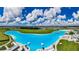 Expansive Crystal Lagoon with beach, lounge areas and surrounding landscape at 5328 Stoic Vale Dr, Wimauma, FL 33598