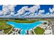 Stunning aerial view of Crystal Lagoon with beach and surrounding landscape at 5328 Stoic Vale Dr, Wimauma, FL 33598
