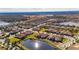 Aerial view of a luxury community with lake and homes at 5328 Stoic Vale Dr, Wimauma, FL 33598