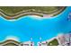 Expansive Crystal Lagoon pool with sandy beach and lounge areas at 5328 Stoic Vale Dr, Wimauma, FL 33598