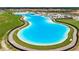 Aerial view of a massive lagoon pool in a community at 5328 Stoic Vale Dr, Wimauma, FL 33598