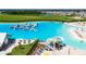 Crystal Lagoon with water features, lounge areas, and sandy beach at 5328 Stoic Vale Dr, Wimauma, FL 33598