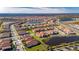 Aerial view of luxury home and lake in new community at 5328 Stoic Vale Dr, Wimauma, FL 33598