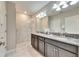 Bathroom with double vanity, granite countertops, and shower at 5328 Stoic Vale Dr, Wimauma, FL 33598