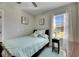 Cozy bedroom with a double bed, nightstand, and window with curtains at 5328 Stoic Vale Dr, Wimauma, FL 33598