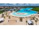 Aerial view of crystal lagoon, beach area, and volleyball at 5328 Stoic Vale Dr, Wimauma, FL 33598