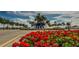 Community entrance with fountain and red flowers at 5328 Stoic Vale Dr, Wimauma, FL 33598