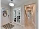 Bright and airy entryway with tile floors and French doors leading to a bedroom at 5328 Stoic Vale Dr, Wimauma, FL 33598