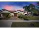 Inviting exterior of a single-story home with landscaping and a two-car garage at 5328 Stoic Vale Dr, Wimauma, FL 33598