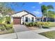 House exterior with a brick driveway and lush landscaping at 5328 Stoic Vale Dr, Wimauma, FL 33598