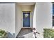 Modern front door with a welcome wreath and a stone pathway at 5328 Stoic Vale Dr, Wimauma, FL 33598