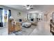 Spacious living room with reclining sofas, ottoman, and tile flooring at 5328 Stoic Vale Dr, Wimauma, FL 33598