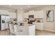 Modern kitchen with white cabinets, granite island and stainless steel appliances at 5640 Silver Moonlight Dr, Palmetto, FL 34221
