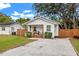 Cute cottage with a gravel driveway and fenced yard at 6297 29Th N St, St Petersburg, FL 33702