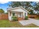 Charming white cottage with brown accents and a welcoming front porch at 6297 29Th N St, St Petersburg, FL 33702