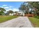 House exterior showcasing a gravel driveway and a fenced yard at 6297 29Th N St, St Petersburg, FL 33702