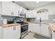 Updated kitchen featuring white cabinets, wood countertops, and stainless steel appliances at 6297 29Th N St, St Petersburg, FL 33702