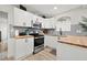 Updated kitchen featuring white cabinets, wood countertops, and stainless steel appliances at 6297 29Th N St, St Petersburg, FL 33702