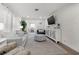 Cozy living room featuring light gray sofa and a large TV at 6297 29Th N St, St Petersburg, FL 33702