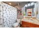 Stylish bathroom with granite vanity and a patterned shower curtain at 6332 Newtown Cir # 32A1, Tampa, FL 33615