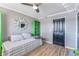 Charming bedroom with daybed, wood floors, and a large mirror at 6332 Newtown Cir # 32A1, Tampa, FL 33615
