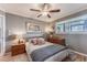 Cozy bedroom with wood furniture and large windows at 6332 Newtown Cir # 32A1, Tampa, FL 33615
