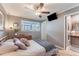 Spacious bedroom with a ceiling fan and en-suite bathroom access at 6332 Newtown Cir # 32A1, Tampa, FL 33615