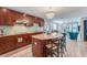 Modern kitchen with granite island, stainless steel appliances, and wood cabinets at 6332 Newtown Cir # 32A1, Tampa, FL 33615
