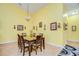 Dining room with wood table and chairs, hardwood floors, and yellow walls at 6723 Basswood Cir, Zephyrhills, FL 33542