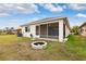 Home exterior with a screened patio and fire pit at 6820 Aramon Ct, Wesley Chapel, FL 33545