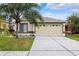 One-story house with a garage and palm tree at 6820 Aramon Ct, Wesley Chapel, FL 33545