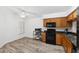 Kitchen with wood cabinets, granite counters and stainless steel appliances at 6820 Aramon Ct, Wesley Chapel, FL 33545