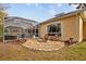 Relaxing patio with fire pit and seating area near the pool at 7153 Woods Bay Ct, Land O Lakes, FL 34637