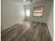 Bedroom with wood-look vinyl flooring and exterior access at 883 Sky Loch S Dr, Dunedin, FL 34698