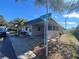 Side view of a house showing the street and part of the carport at 883 Sky Loch S Dr, Dunedin, FL 34698