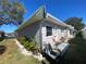 Side view of a house with landscaping and a portion of the street at 883 Sky Loch S Dr, Dunedin, FL 34698