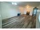 Bright living room featuring light wood laminate flooring and neutral walls at 883 Sky Loch S Dr, Dunedin, FL 34698