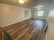 Spacious living room with wood-look floors and a ceiling fan at 883 Sky Loch S Dr, Dunedin, FL 34698