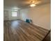 Living room with wood-look floors and large artwork on the wall at 883 Sky Loch S Dr, Dunedin, FL 34698