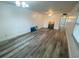 Bright living room featuring wood-look floors and large artwork at 883 Sky Loch S Dr, Dunedin, FL 34698