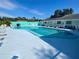 Community pool with surrounding lounge chairs at 883 Sky Loch S Dr, Dunedin, FL 34698
