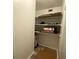 Storage closet with shelving and water heater at 883 Sky Loch S Dr, Dunedin, FL 34698