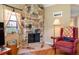 Cozy living room with stone fireplace and comfortable armchair at 10172 Seminole Island Dr # 10172, Largo, FL 33773