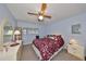 King-size bed, dresser, and ceiling fan in bedroom at 102 Cambridge Trl # 225, Sun City Center, FL 33573