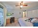 Bedroom with queen bed, dresser, and access to patio at 102 Cambridge Trl # 225, Sun City Center, FL 33573